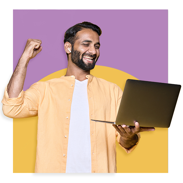 A man celebrating with laptop in his hand